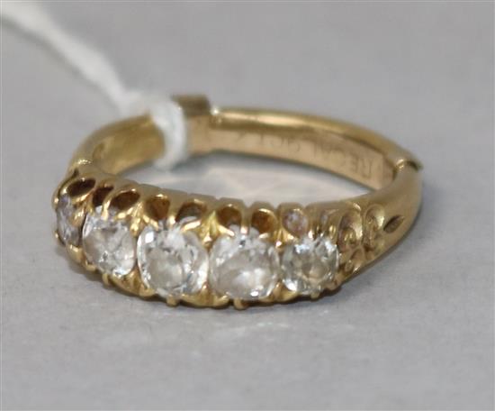 A late Victorian 18ct gold and graduated five stone diamond half hoop ring, size L.